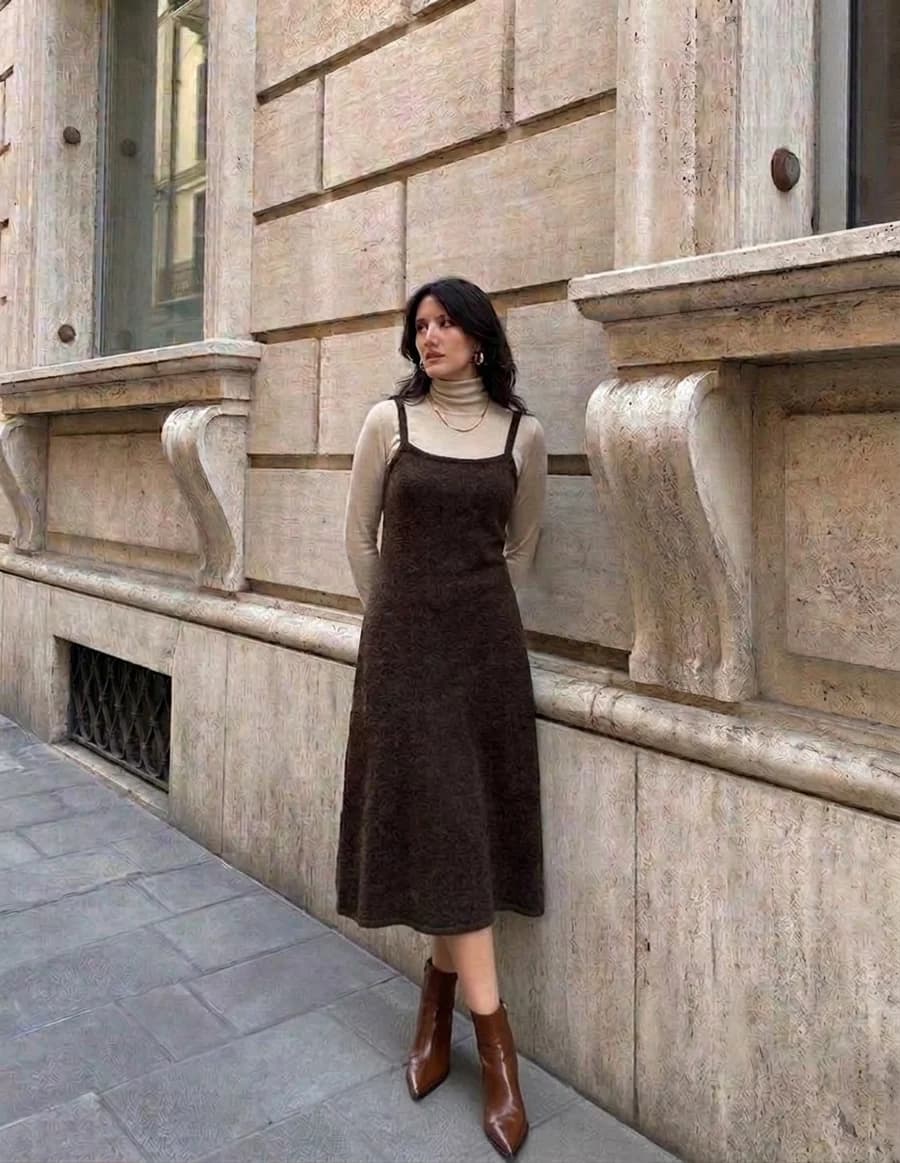 Dinner date outfit: brown sleeveless midi dress over a cream fine-gauge roll neck with ankle boots