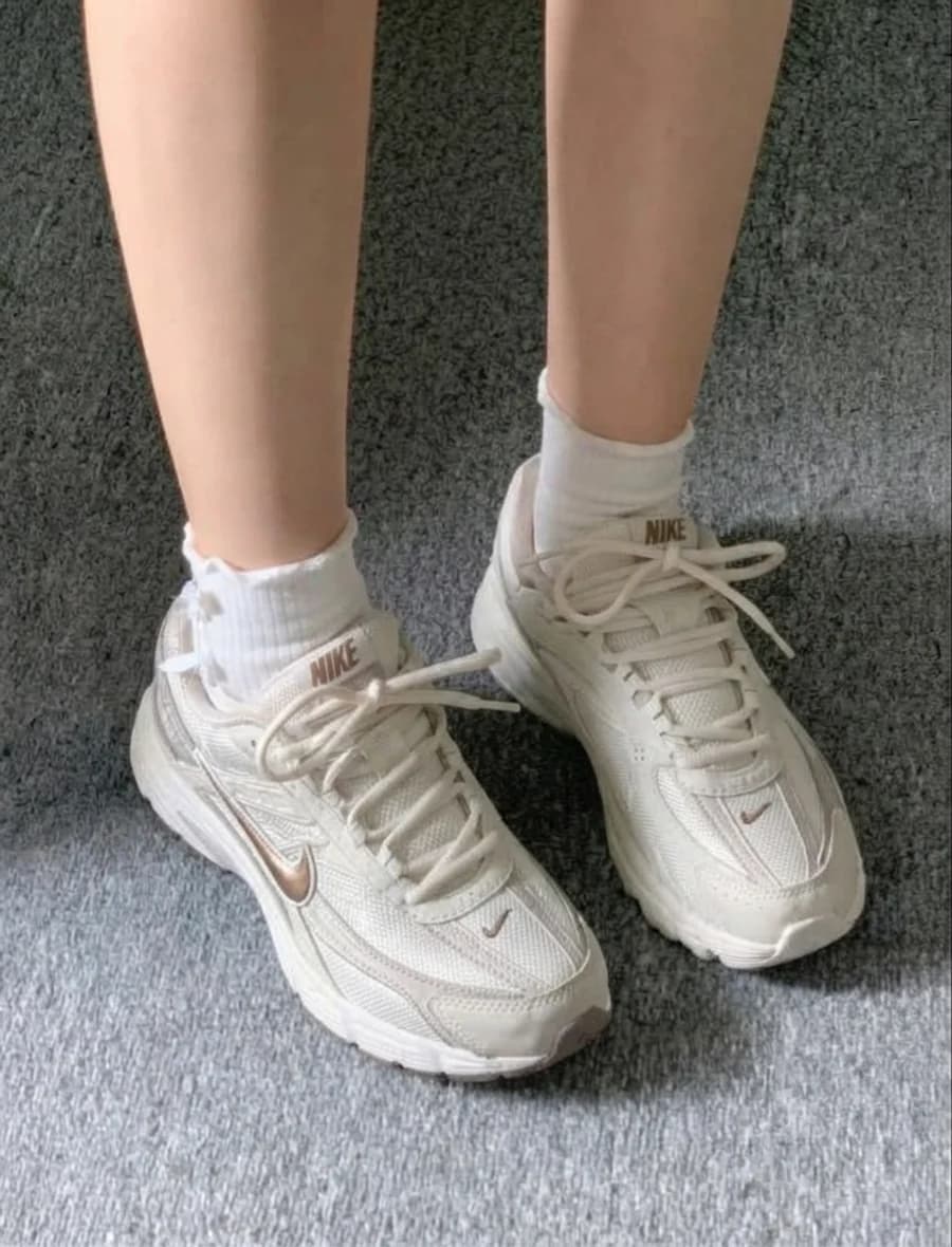 Women's cream retro running sneakers with metallic accents and white socks
