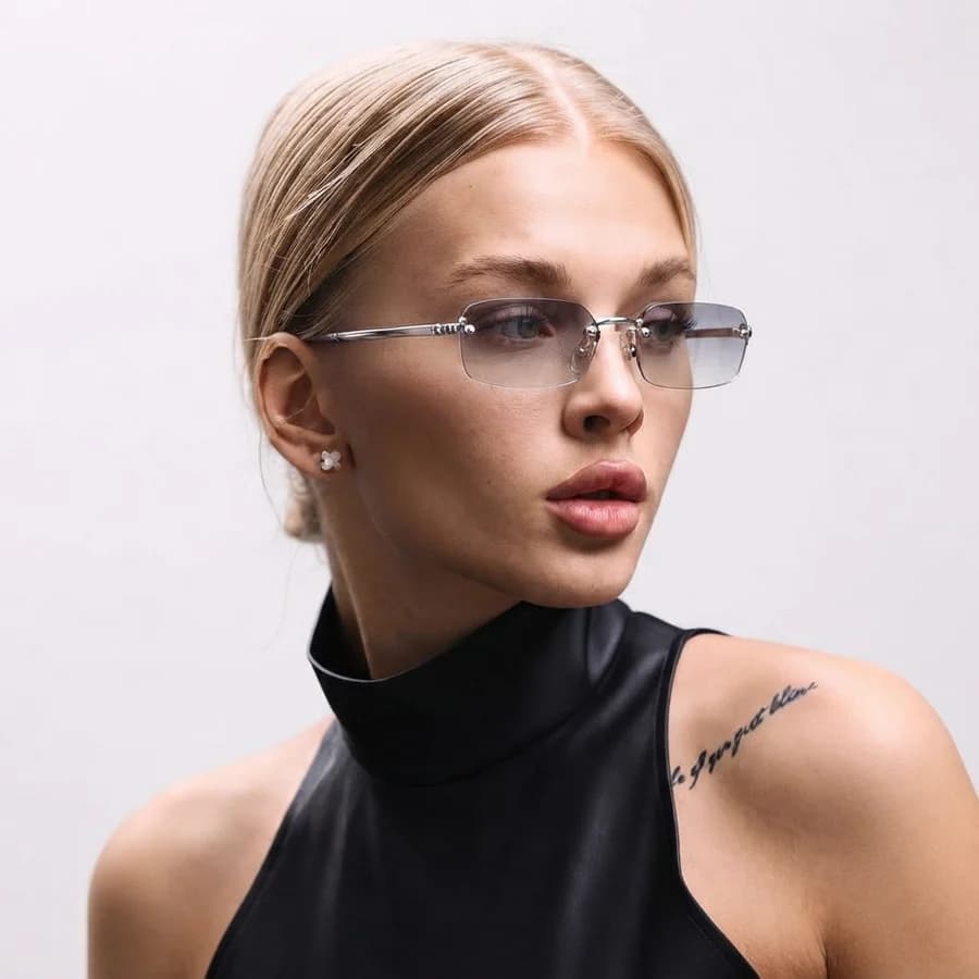Women's rimless rectangle Y2K sunglasses with gradient lenses and a black sleeveless top