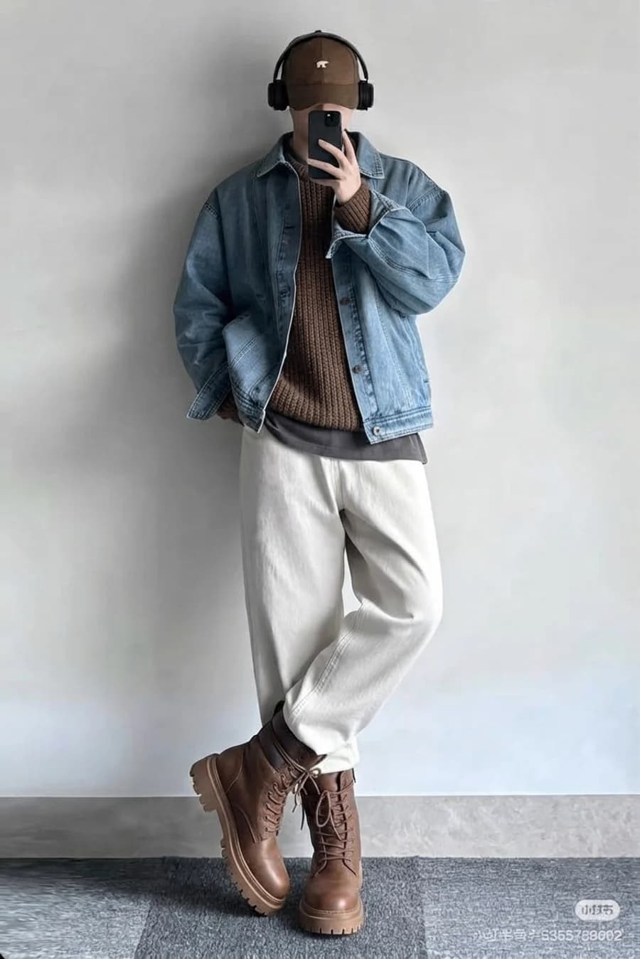 Cold-weekend layering: light denim jacket over a brown knit and cream wide trousers with work boots