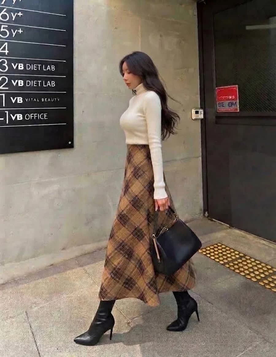 Autumn outfit: cream turtleneck with a camel plaid maxi skirt and black ankle boots