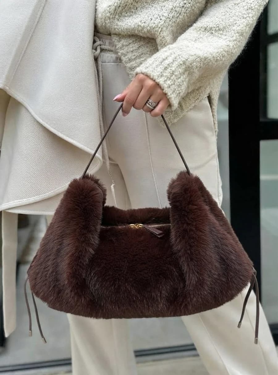 Chocolate faux fur shoulder bag with cream knit and drawstring trousers