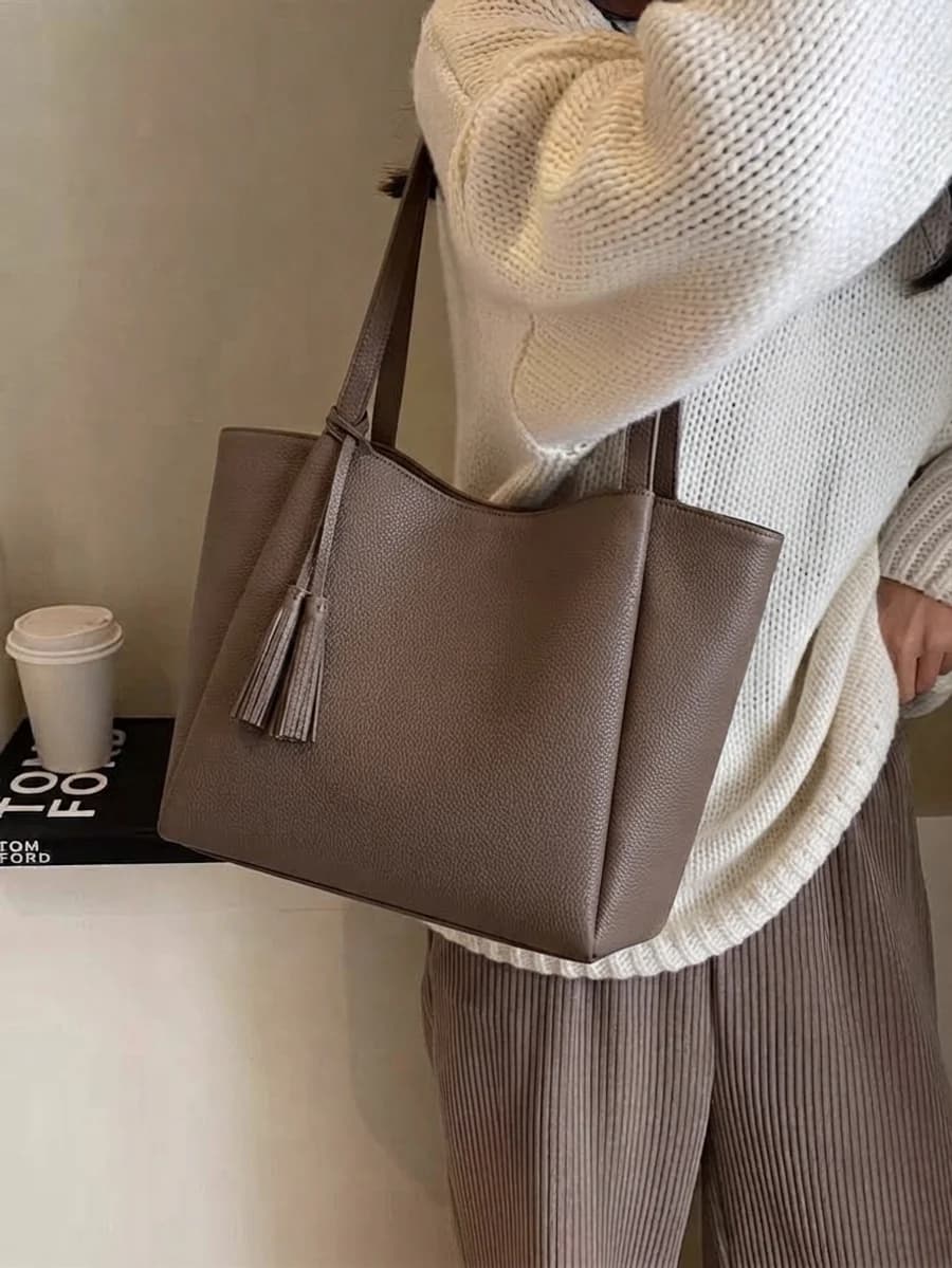 Greige pebbled leather tote with a cream chunky knit and corduroy trousers