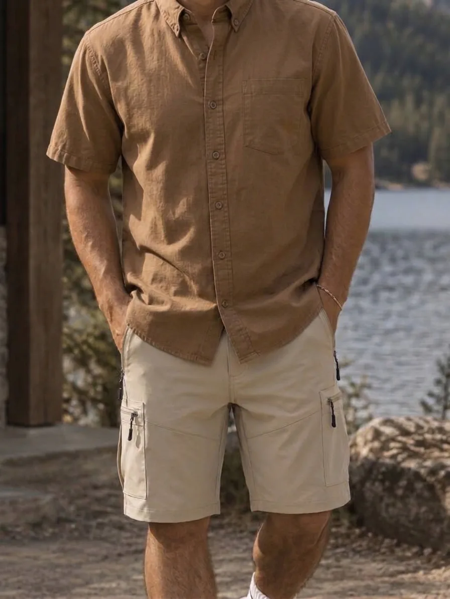 Beige cargo shorts with zip pockets, worn with a brown short-sleeve shirt