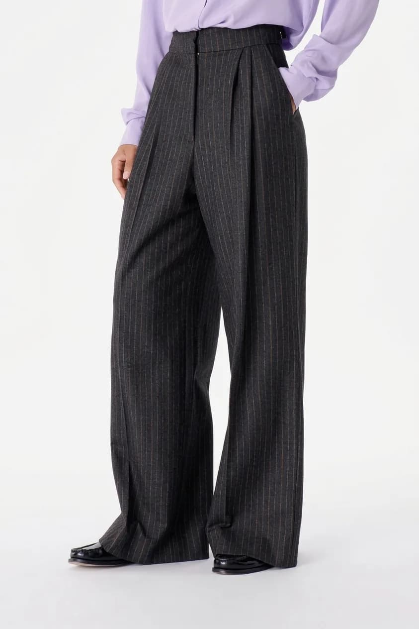 Charcoal wide-leg trousers with a fine pinstripe, worn with a lilac shirt and black loafers