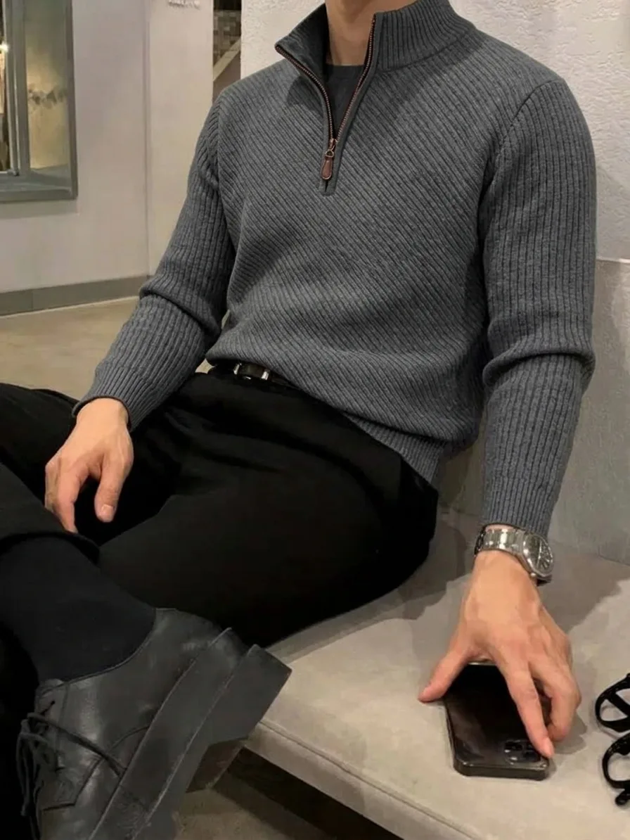 Grey ribbed quarter-zip sweater worn with black trousers, black socks, and black lace-up shoes