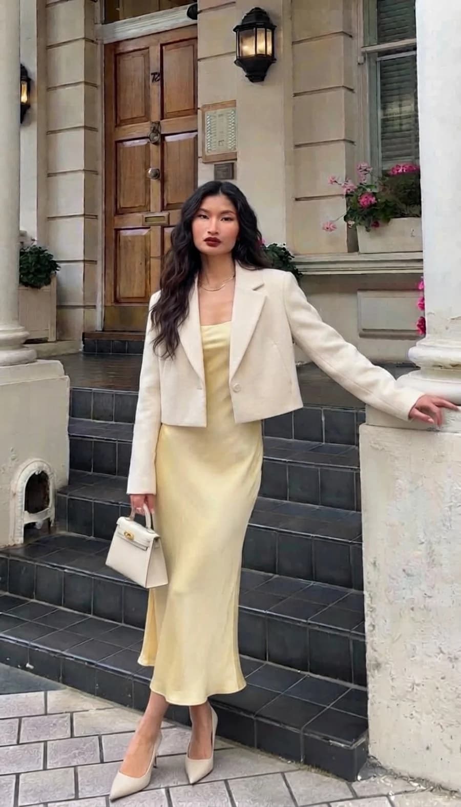 Date night outfit: butter yellow satin slip dress with a cropped cream blazer and nude pointed pumps