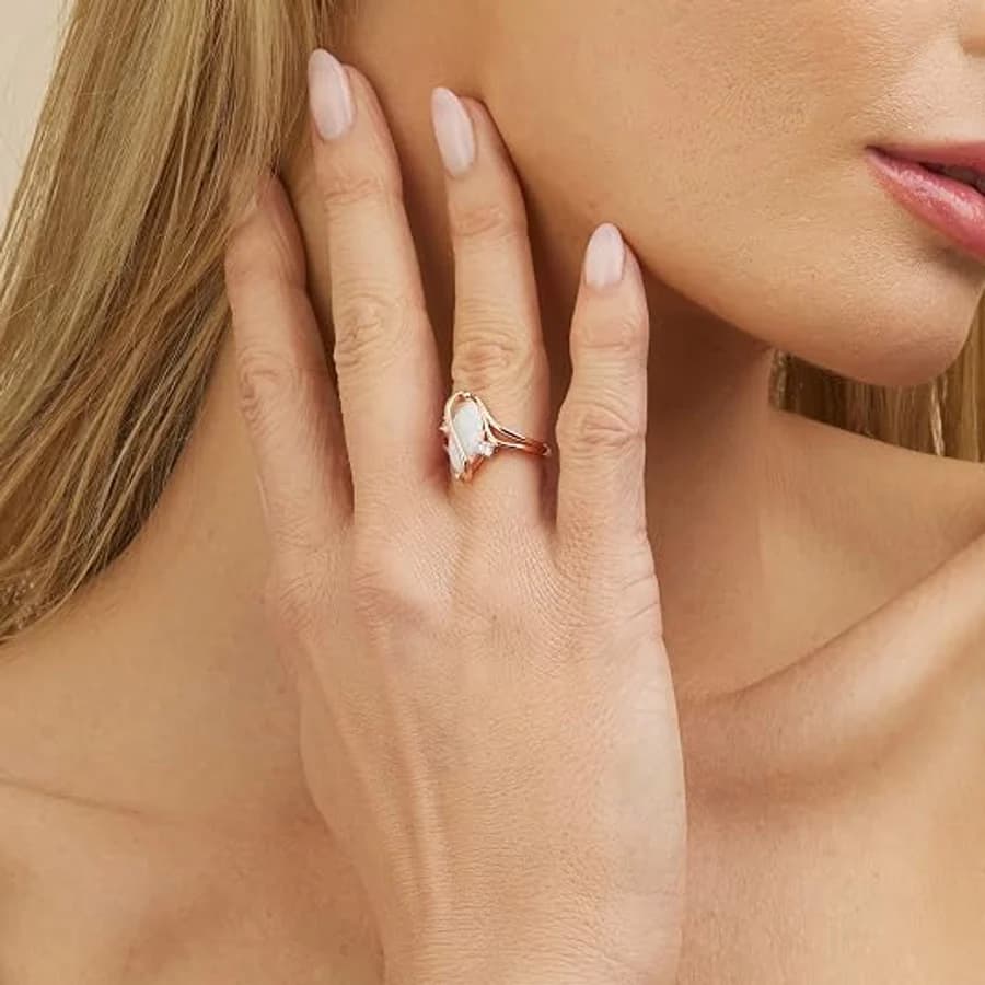 Rose gold bypass ring with a marquise opal and small accent stone