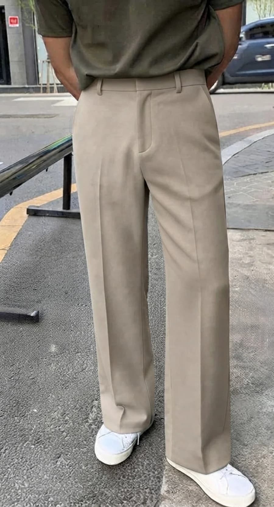 Smart office casual: olive tee tucked into beige creased trousers with white sneakers