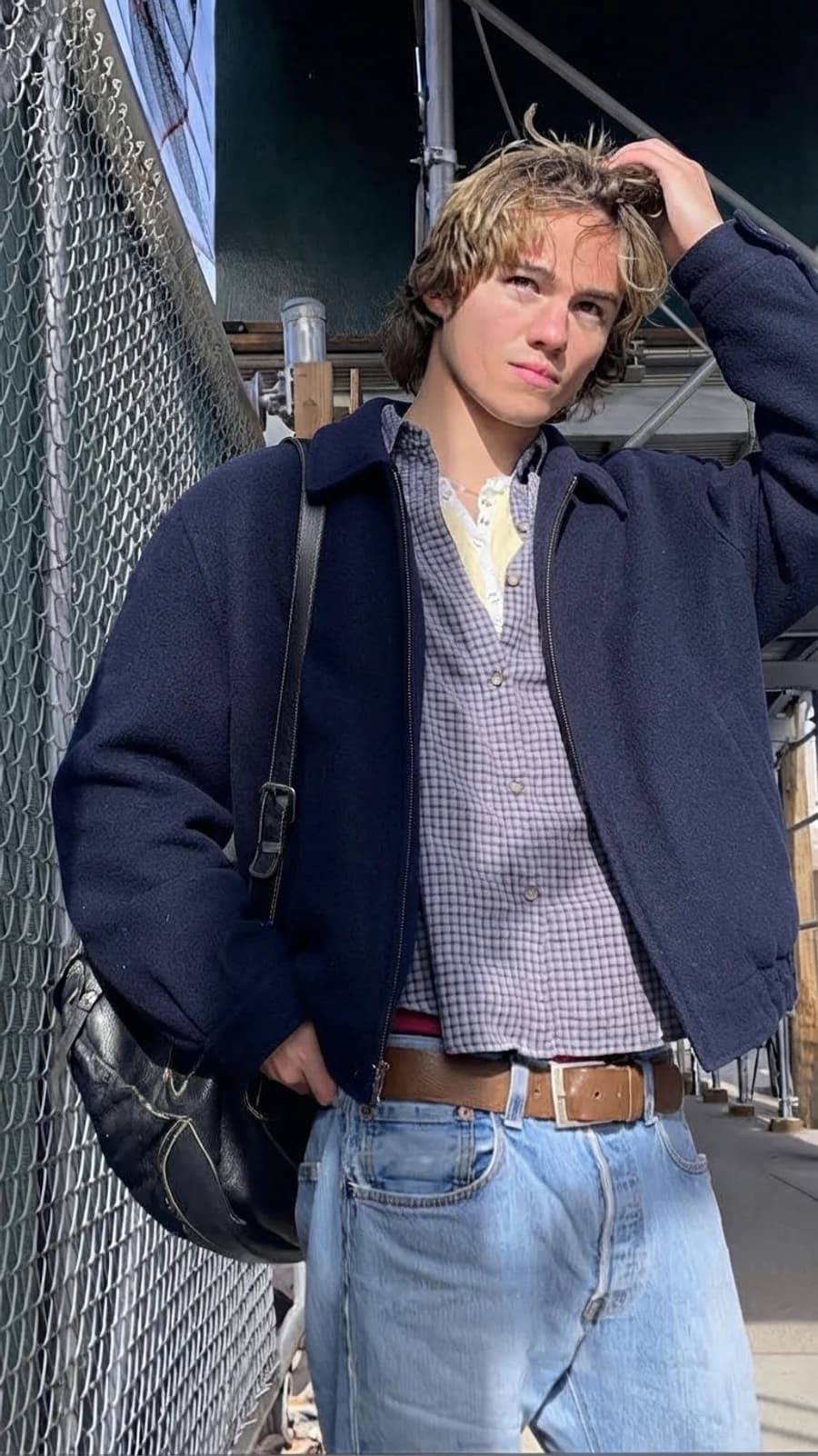 Creative office dressing: navy zip jacket over a check shirt with light-wash straight denim