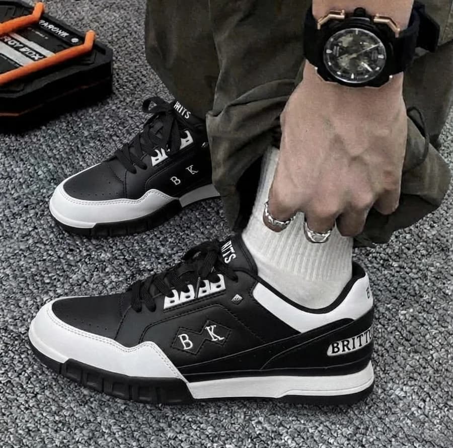 Men's black and white chunky sneakers with cargo trousers and white socks