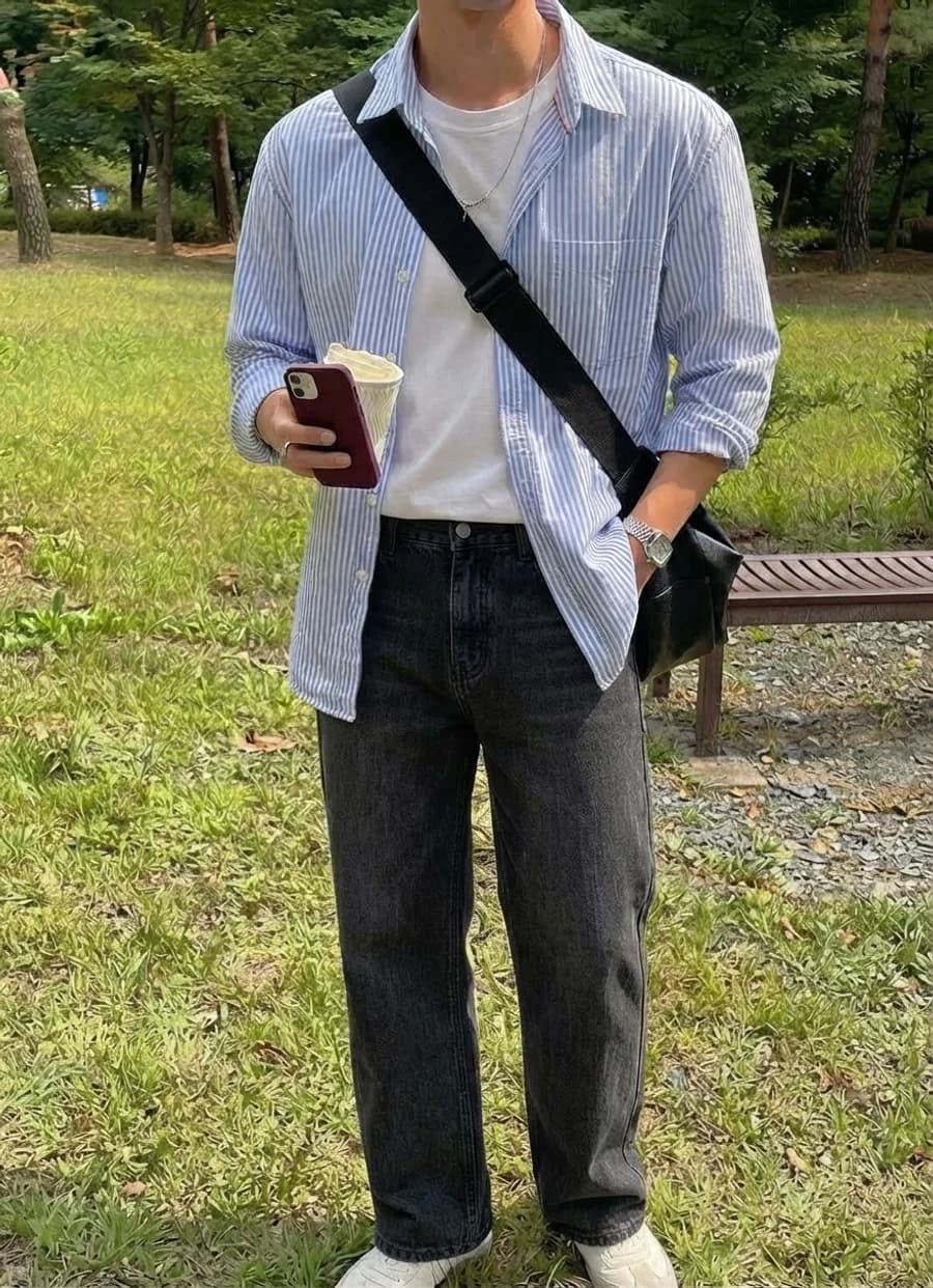 Men's spring style guide: open striped shirt over a white tee with dark jeans