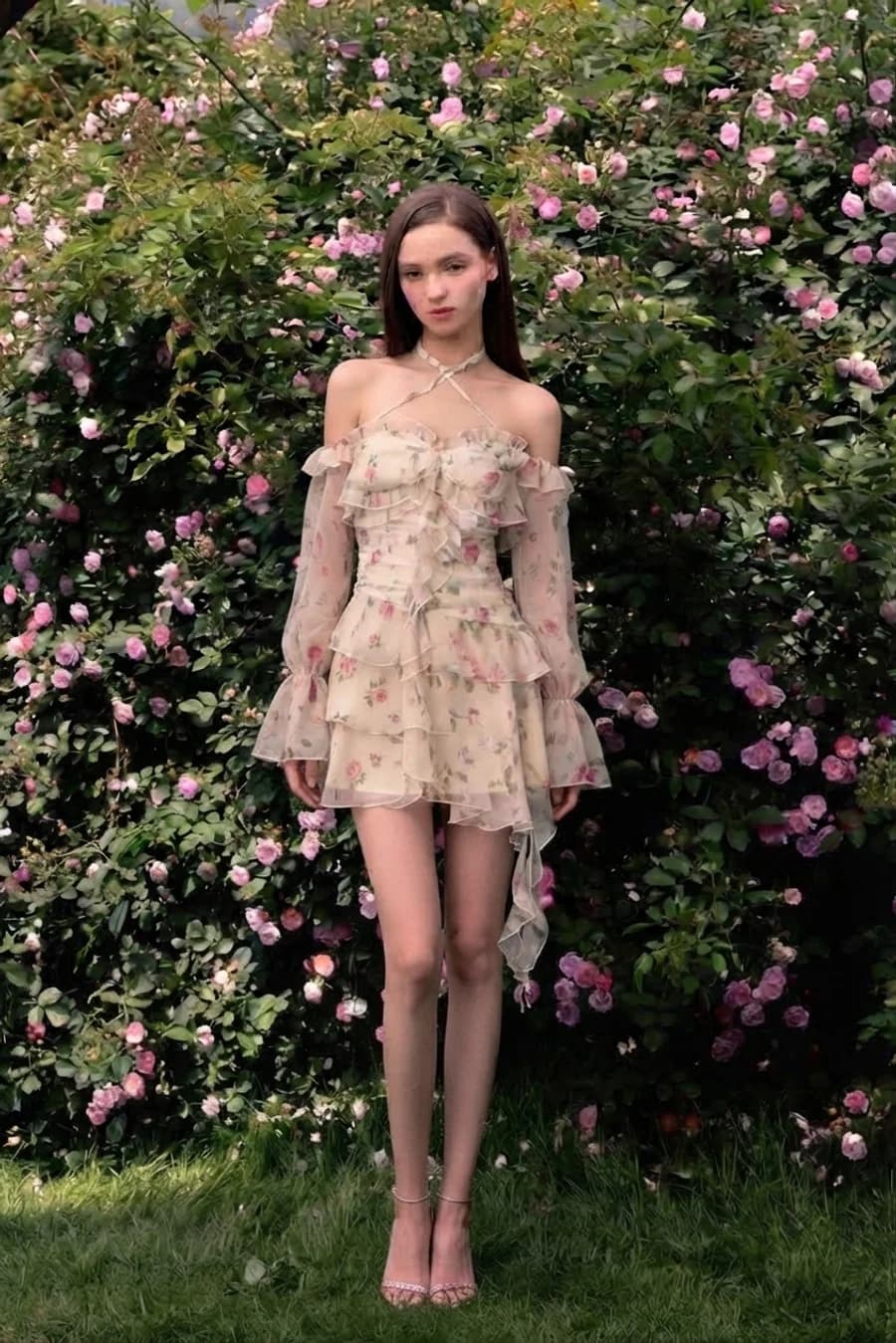 Women's spring outfit: ruffled floral mini dress in a rose garden