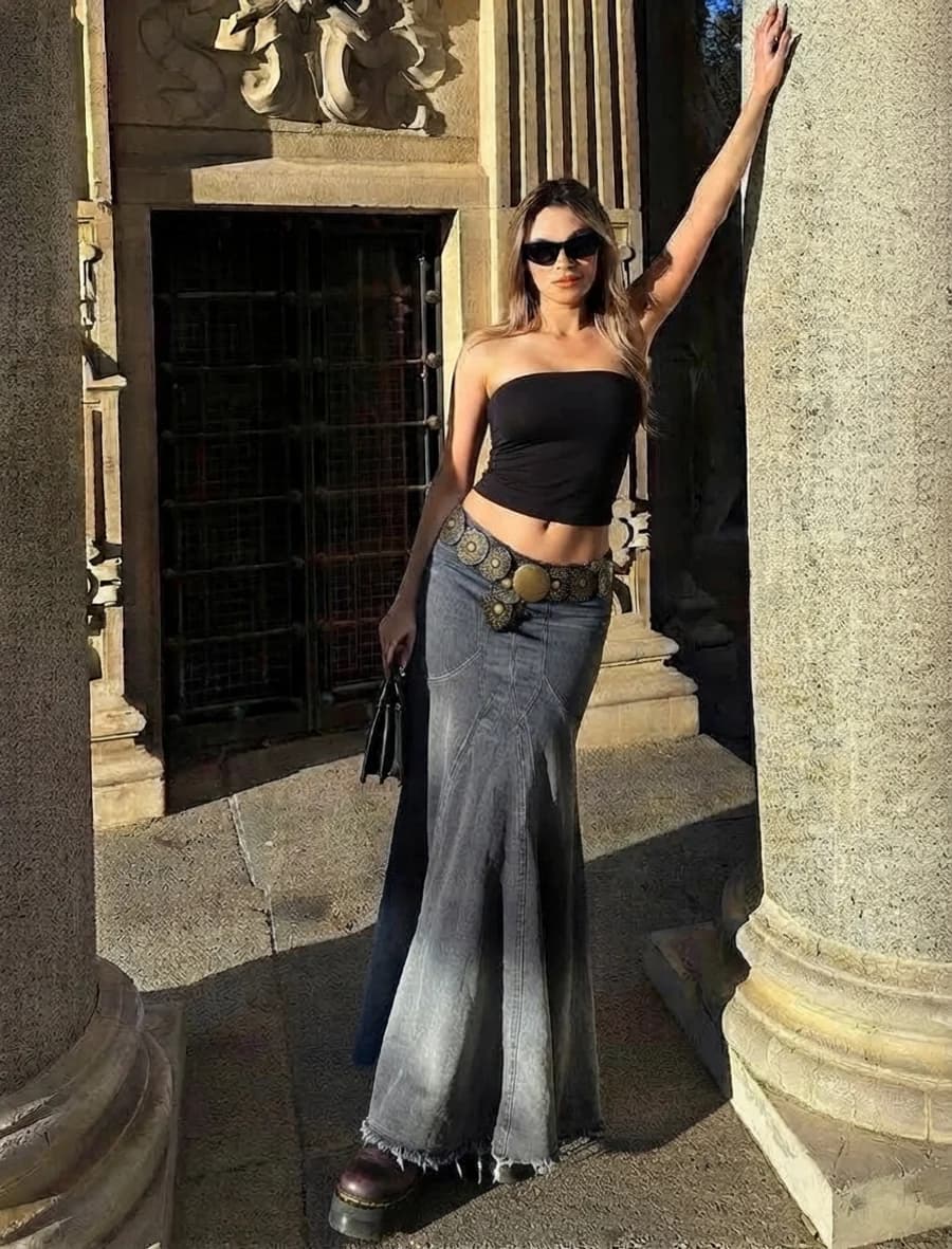 Women's spring outfit: black tube top with a grey denim maxi skirt and platform boots