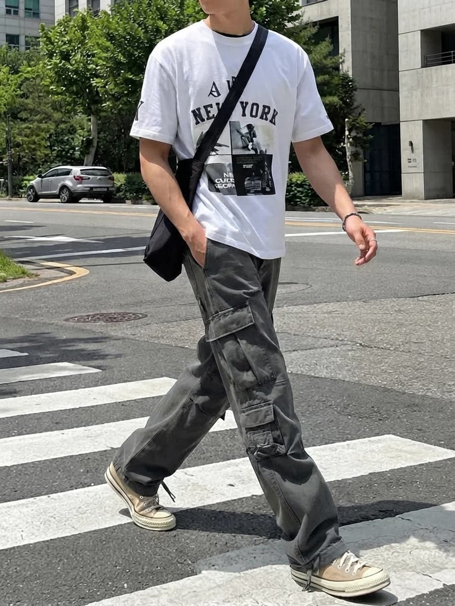 Men's summer outfit: white graphic tee with grey cargo trousers and tan high-tops