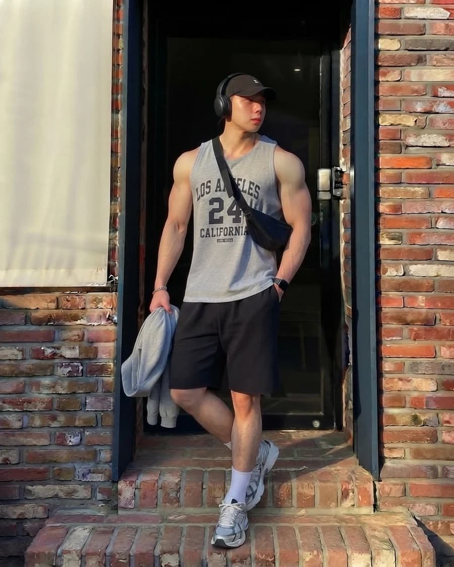 Men's summer outfit: grey jersey tank with black athletic shorts and trainers