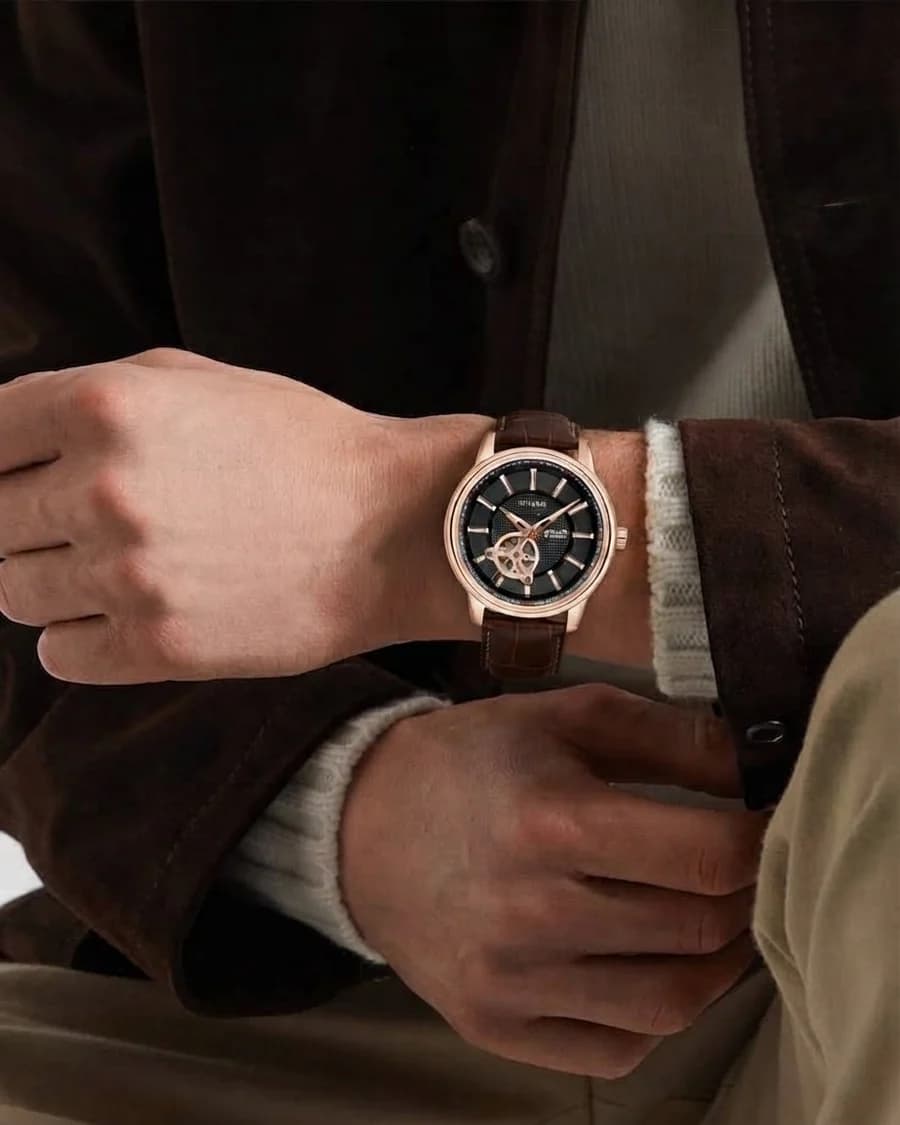 Bulova men's open-heart automatic watch with a brown leather strap and suede jacket