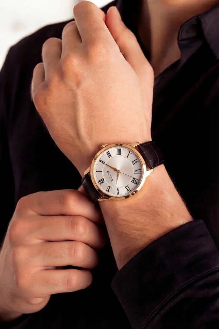 Bulova men's gold dress watch with Roman numerals and a brown croc strap