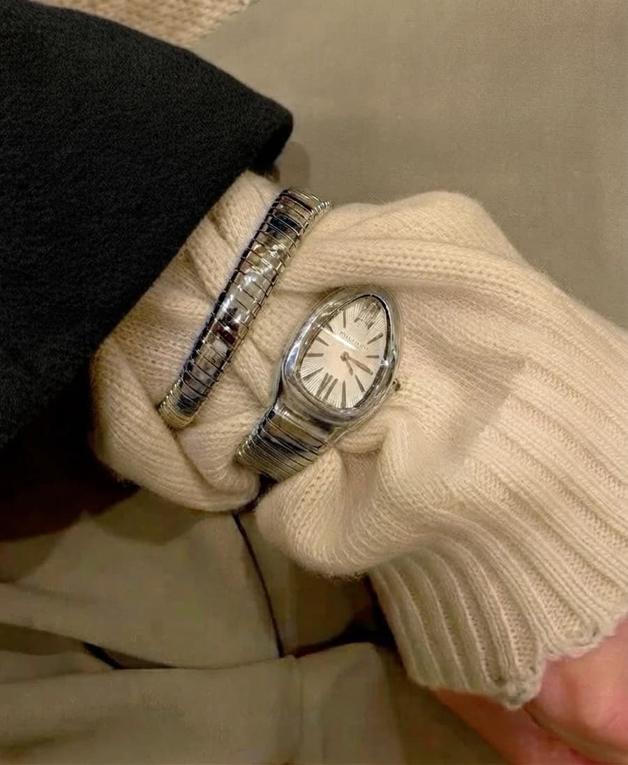 Women's tubogas serpenti-style watch with a matching bracelet on a cream sweater
