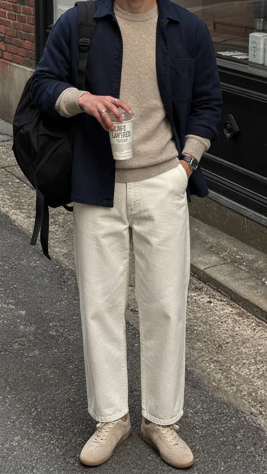 Neutral weekend layers: navy overshirt over an oatmeal knit with cream wide chinos and tan trainers