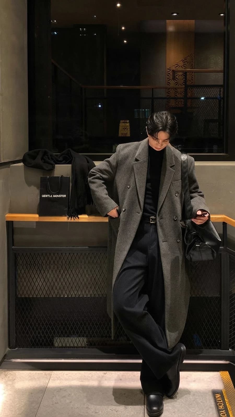 Men's winter style guide: charcoal double-breasted overcoat with black turtleneck and trousers