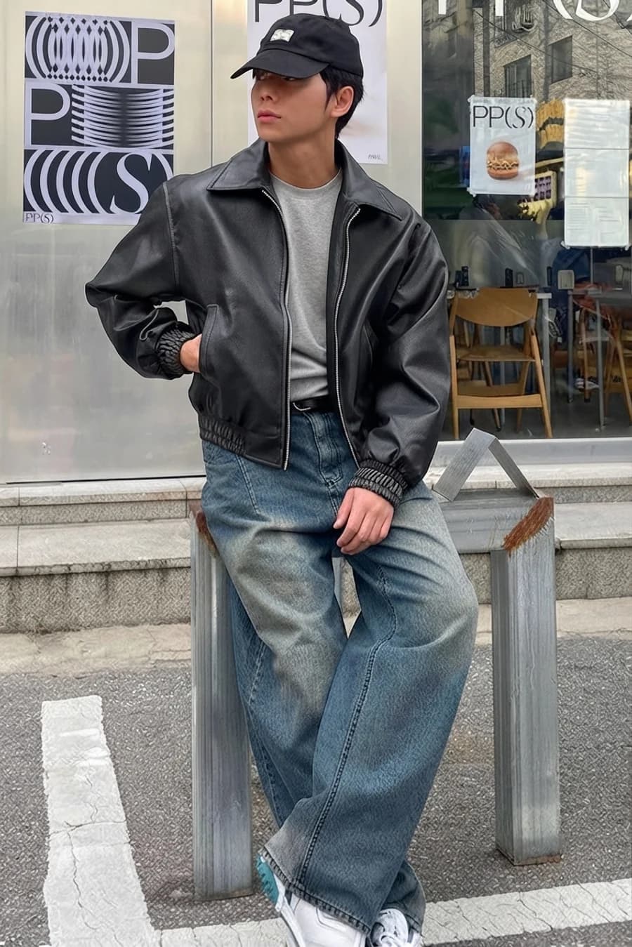 Men's winter outfit: black leather bomber with grey sweater and wide light-wash jeans