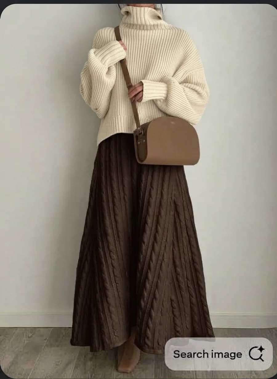 Women's winter outfit: cream turtleneck with a chocolate cable-knit maxi skirt